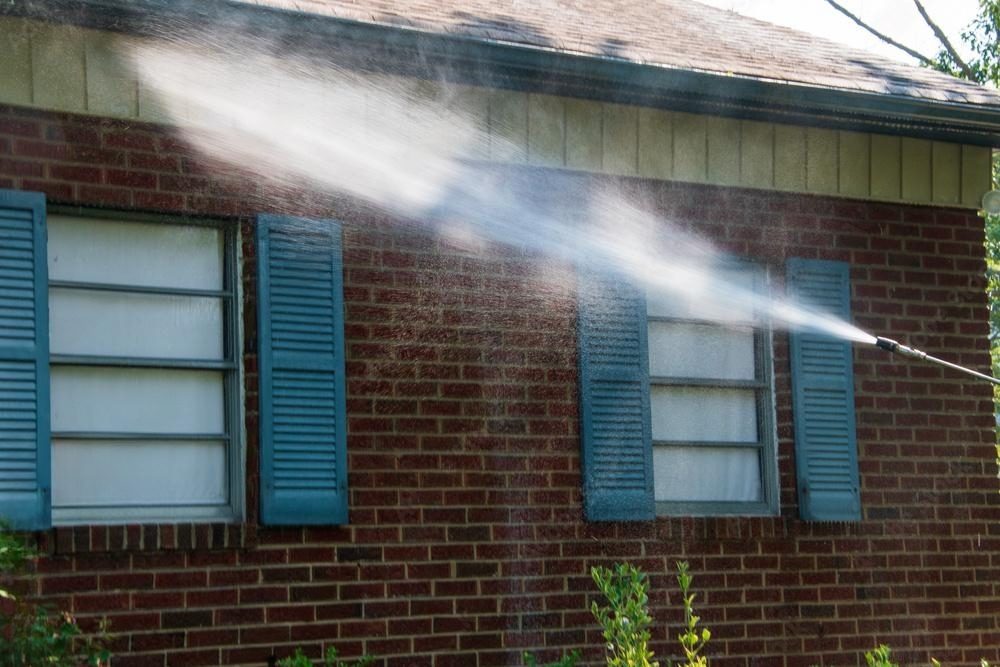 Brick house being power washed.