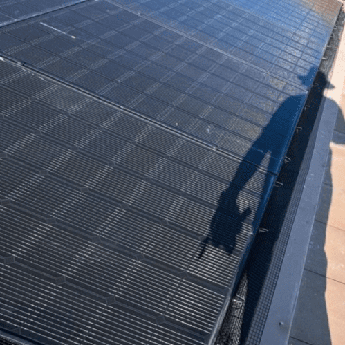 Solar panel with shadow of a person.