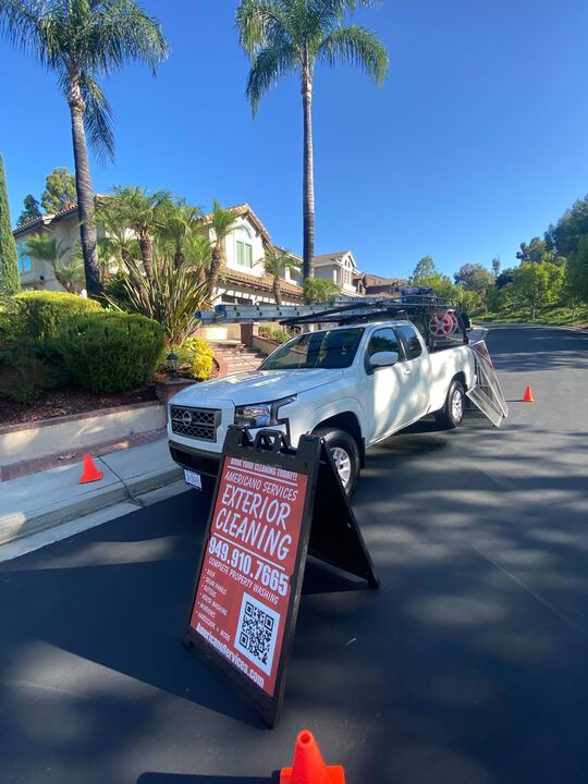 White truck with exterior cleaning sign.