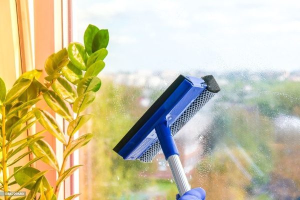 Squeegee cleaning a window pane.