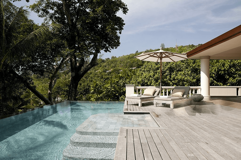 Luxury resort pool with deck chairs.