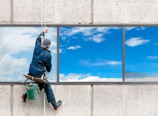 Window washer hanging from a rope.