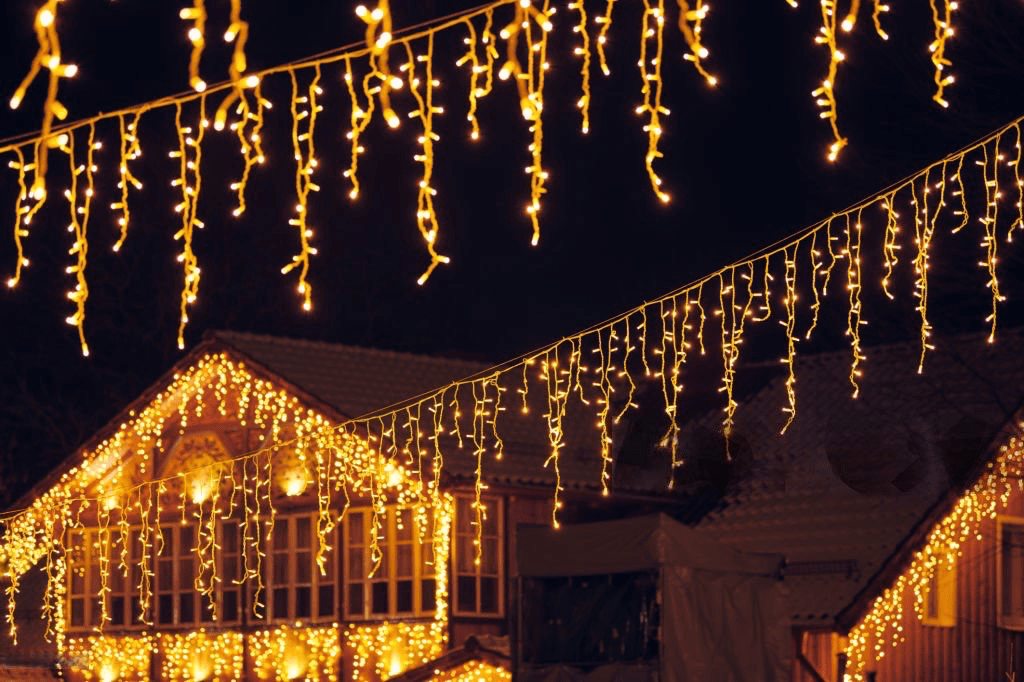 String lights illuminating a building at night.