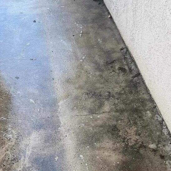 Before and after pressure washing concrete.