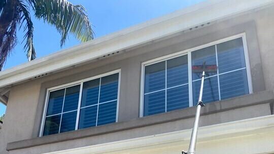 Window cleaning with an extension pole.